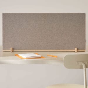 A Dezibel Flexible Table Screen in an office at a desk with a chair