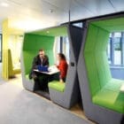 JDD Bill Office Pods in bright green with two people meeting inside the workspace pod