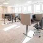 Wide view of the Optima Tables in a modern, busy workplace