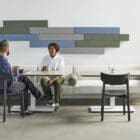 Timber Wall Absorbers in an office behind a sofa where a conversation is taking place and providing acoustic dampening