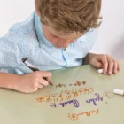 Clear Whiteboard Paint from Smarter Surfaces being used on a table by a child