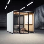 Framery Six standalone in a dark room and lit up internally