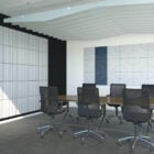 The Opus collection features a series of 8 unique, modular acoustic blades in a boardroom with blue acoustic panels