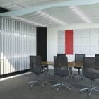 The Opus collection features a series of 8 unique, modular acoustic blades in a boardroom with red acoustic panels